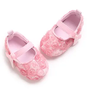 Elegant pink baby Mary Jane shoes featuring delicate floral lace and satin bow details