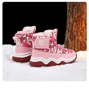 Detail view of pink camouflage snow boots with thick white plush lining for kids