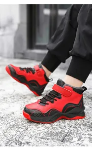 Close-up of boys' red and black fleece-lined sneakers for winter outdoor basketball.