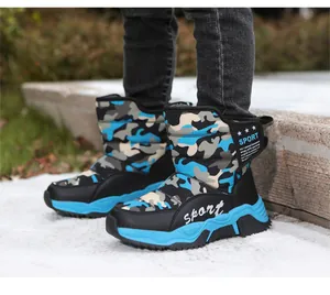 Detailed view of kids' camouflage snow boots with thick anti-slip blue rubber soles