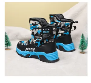 Detailed view of children's camouflage snow boots with blue non-slip soles and warm lining.