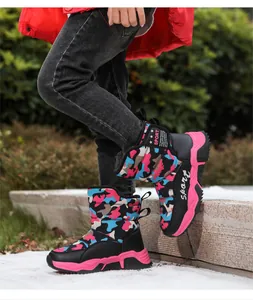 Detailed view of children's camouflage snow boots with pink anti-slip soles