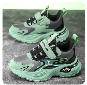 Macro detail view of mint green boy's chunky sneakers with velcro strap and thick sole
