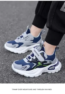 Detailed side view of boy's navy blue and grey non-slip fashion sports sneakers.