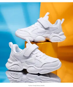 Detailed side view of white breathable children's running shoes with hook and loop strap