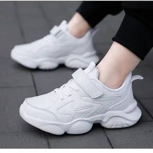 Close-up detail of white breathable children's running shoes with hook-and-loop strap.