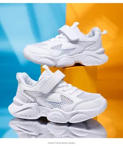 Detailed view of white breathable mesh sneakers for boys with soft lightweight soles.