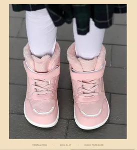 Close-up front view of pink children's winter snow boots with warm fleece lining and straps