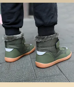 Detail view of kids olive winter boots featuring warm faux fur lining and velcro closure.