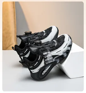 Detail of black and white kids' warm sports shoes with rotary dial lacing system.