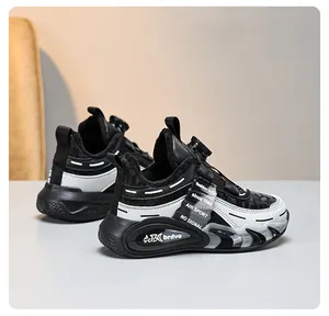 Detailed side view of children's black and white winter running shoes with rotary dial system