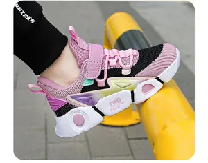 Detailed macro view of breathable pink and black children's sneaker with secure velcro strap