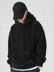Close-up of a men's black coral fleece hoodie showing thick and soft texture details.
