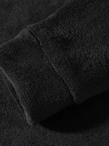 Macro view of plush coral fleece fabric on a men's sweatshirt sleeve cuff