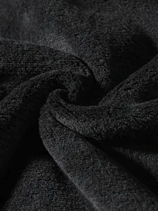 Macro detail shot of soft black coral fleece fabric showing plush texture and fibers