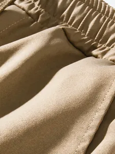 Macro detail of khaki cargo pants showing high-quality cotton twill fabric and elastic waist