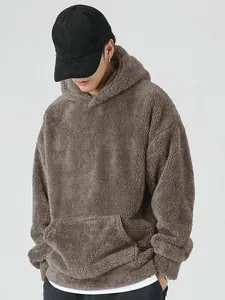 Detail of men's fuzzy taupe sherpa hoodie with kangaroo pocket for autumn and winter