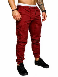 Close-up detail of men's burgundy cargo joggers featuring drawstring waist and side pockets
