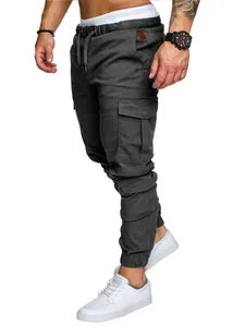 Close-up detail of men's dark grey cargo jogger pants featuring side pockets and cuffs