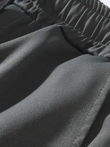 Close-up of men's cargo pants detail showing elastic waistband and twill fabric texture
