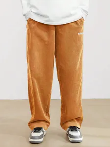 Detail view of men's brown corduroy straight-leg trousers in retro streetwear style