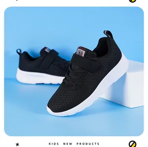 Detailed view of breathable mesh texture and velcro strap on kids black sneakers