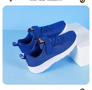 Detailed view of blue breathable mesh kids sneakers with lightweight white rubber soles