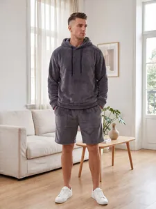 Volledige weergave van een man in een comfortabele antracietgrijze koraalfluwelen set