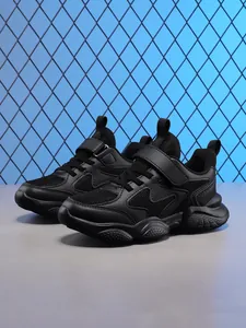 Close-up detail of black breathable children's running shoes with mesh upper textures
