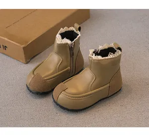 Detailed side view of girls' khaki boots with lace trim and convenient zipper closure