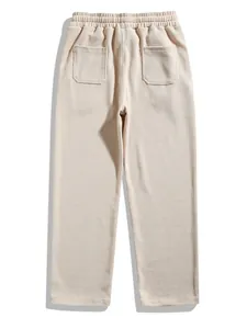 Back view detail of beige men's corduroy pants with elastic waist and pockets.