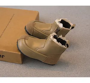 Detailed view of girls leather boots featuring lace trim and warm fleece lining