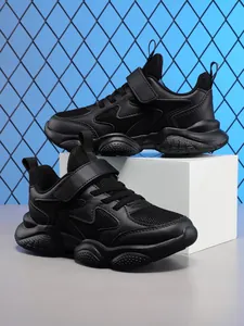 Detail view of boys' black breathable running shoes with durable soft soles.
