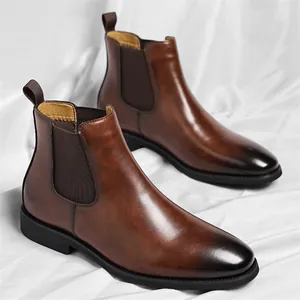 Vintage men's brown leather Chelsea boots with burnished toe on white background