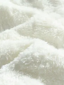 Close-up macro view of soft white sherpa fleece fabric texture of the men's cozy set