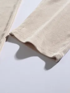 Macro view of beige corduroy fabric texture and hem on vintage men's straight trousers