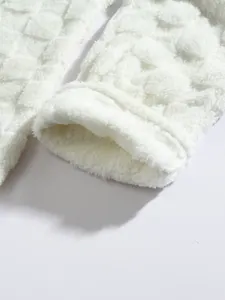 Macro detail of white fuzzy fleece fabric with 3D plaid texture on men's loungewear set