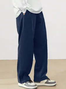 Detailed view of men's navy blue corduroy straight-leg trousers in retro style