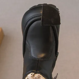 High-quality black leather Martin boots for girls with velcro detail and lace lining.