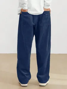 Back view detail of men's dark blue straight-leg corduroy trousers with functional pockets