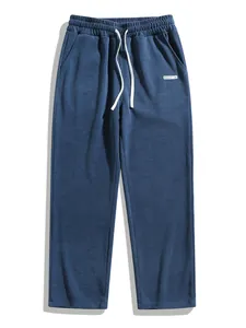 Detailed view of men's blue corduroy straight-leg pants with elastic waist drawstring