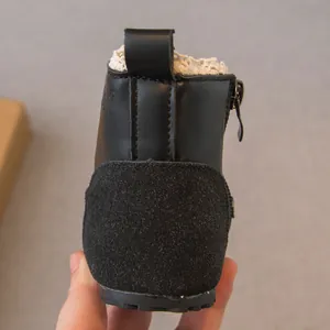 Detailed rear view of black girls' Martin boots with side zipper and lace lining