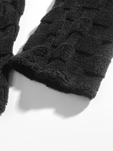 Close-up of black fuzzy square grid texture on men's winter casual set