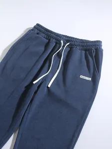 Macro view of blue corduroy pants with elastic waistband and drawstring detail