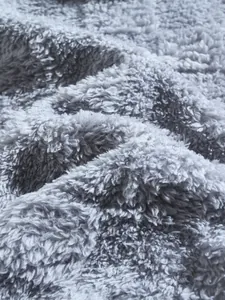 Macro view of soft grey fuzzy fleece fabric texture on men's winter casual loungewear