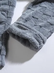 High-quality close-up detail of grey fuzzy fleece fabric with square grid pattern textures