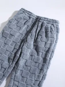 Detailed view of grey checkered fuzzy plush fabric on men's winter casual pants