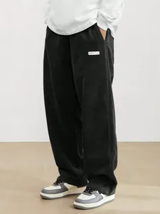 Detailed view of mens retro dark corduroy straight leg high street fashion trousers