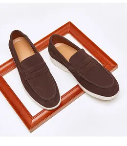 Close-up of men's brown suede leather loafers with classic white contrast rubber sole