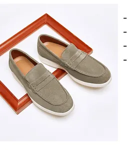 Elegant men's olive green suede loafers with white rubber sole in a classic slip-on design